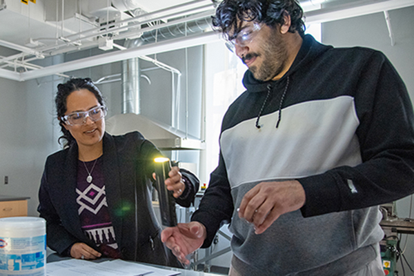 Undergraduate student with professor in lab